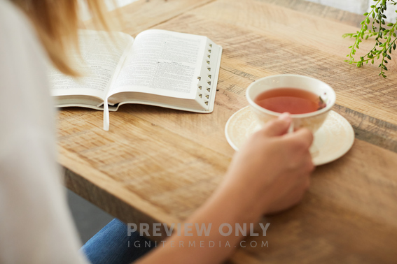 A Woman With A Tea Cup Reading A Bible Stock Photos Prixel Creative