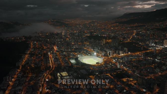 Nighttime Drone Shot Over Quito Shows Lit Up Atahualpa Olympic Stadium