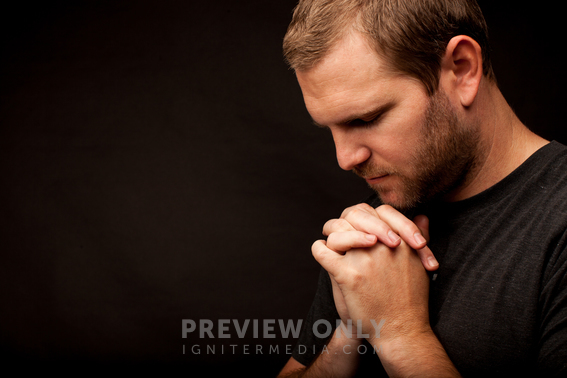 A Man With His Head Bowed In Prayer - Stock Photos | Pearl