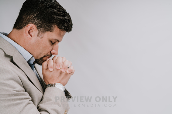 A Man With Head Bowed Praying - Stock Photos 