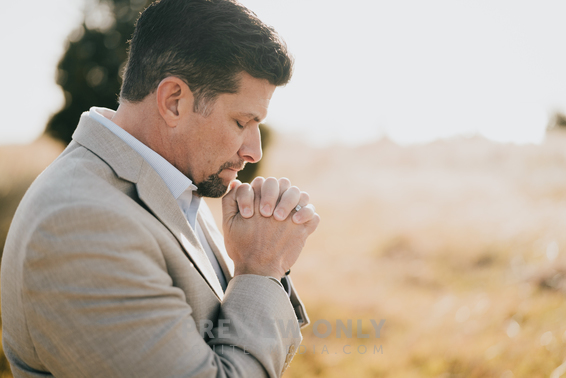 A Man Praying In A Field - Stock Photos | Pearl