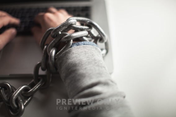 Wrists Bound With Chain Working On A Laptop Computer. - Stock Photos ...