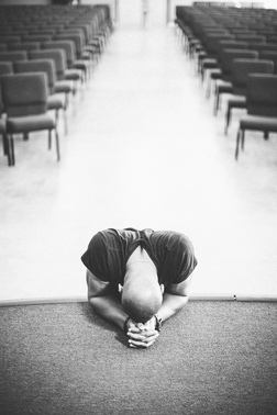 kneeling in prayer at altar