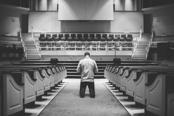 Man Kneeling In The Aisle Of A Church In Front Of The Altar - Stock ...