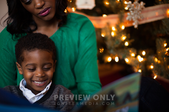 Mother And Son Reading A Christmas Story In Front Of A Christmas Tree ...