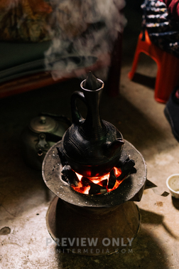 Ethiopian Coffee Pot Sitting On Hot Coals For A Coffee Ceremony - Stock 