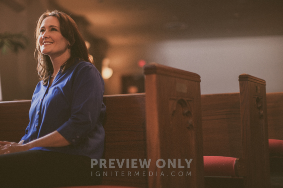 Woman Sitting In A Pew In A Church Smiling - Stock Photos | Pearl