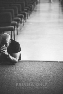 Man Leaning On Stage With Eyes Closed In Prayer. - Stock Photos | Pearl