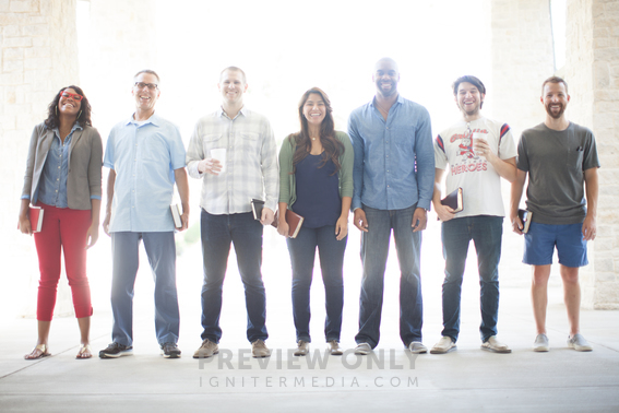 Seven People Standing In A Line Smiling And Holding Bibles Stock