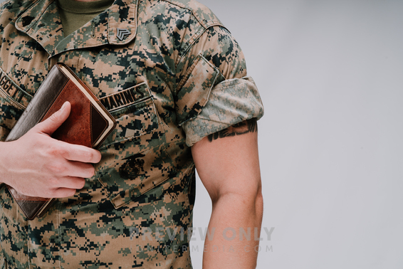 A Marine Holding A Bible To His Chest - Stock Photos | Pearl