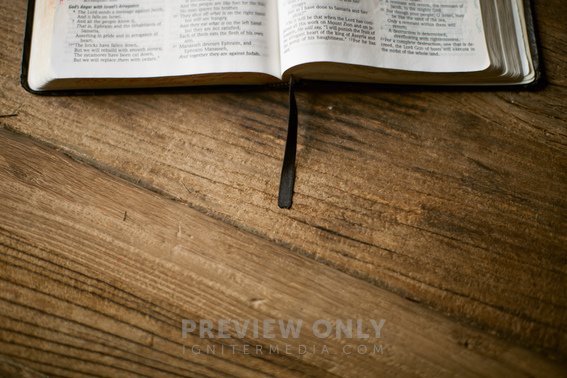 Edge Of An Open Bible Lying On A Wood Table - Stock Photos | Pearl