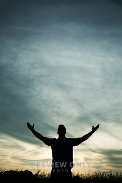 A Silhouette Of A Man Looking Up With Raised Arms At Sunset. - Stock ...