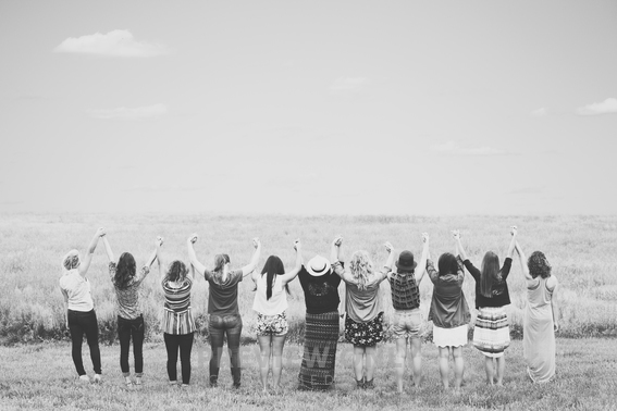 Teen Girls Standing In A Field Of Grass Holding Hands, With Arms Raised ...