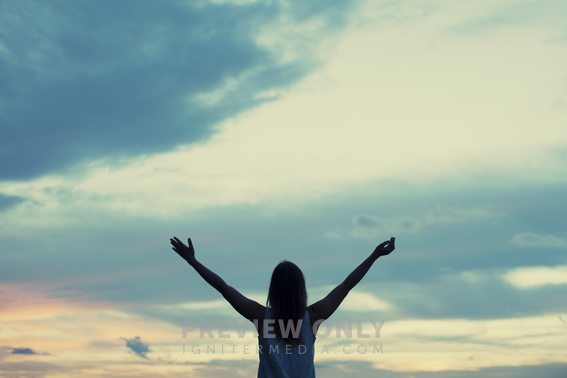 Woman Standing Outside With Arms Raised High In Praise. - Stock Photos ...