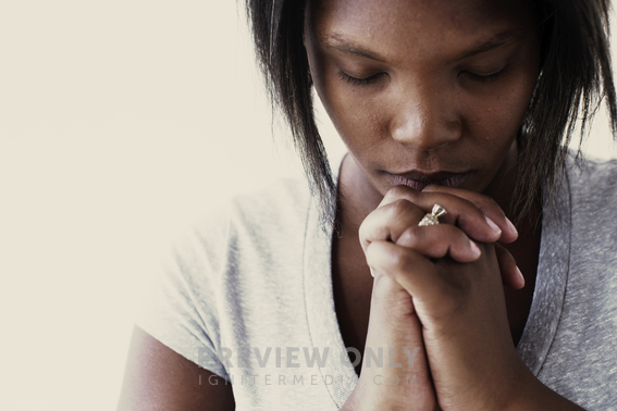 African-American Woman With Head Bowed In Prayer - Stock Photos ...