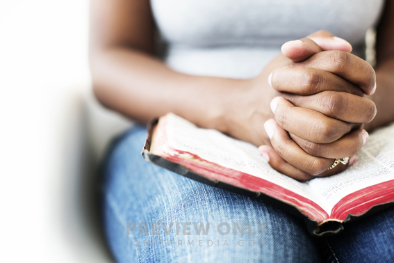 African-American Woman Reading A Bible In Her Lap - Stock Photos ...