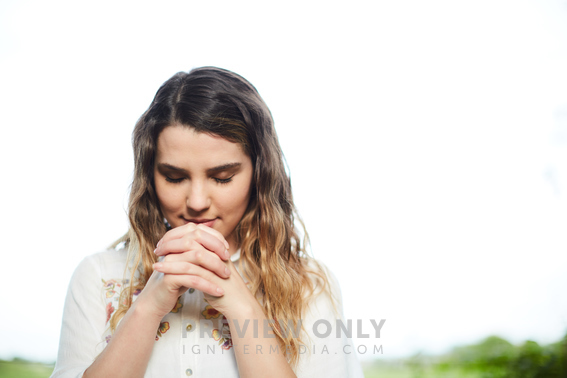 A Young Woman With Head Bowed In Prayer - Stock Photos | Prixel Creative