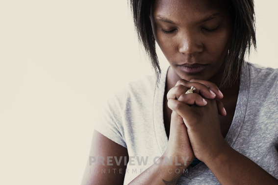 African-American Woman With Head Bowed In Prayer - Stock Photos ...