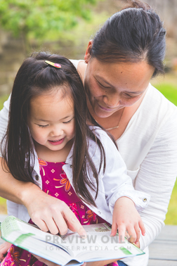 A Mother Reading A Bible To Her Daughter - Stock Photos | Neely Wang