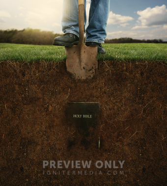 Digging In The Dirt To Uncover A Holy Bible. - Stock Photos | Kevin Carden