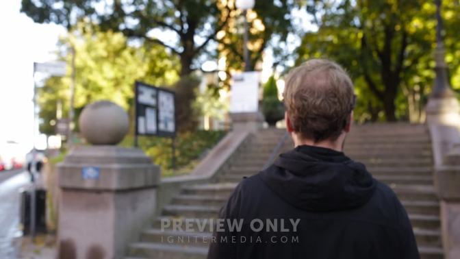 Man Walking Outdoors On Sidewalks Through A College Campus - Stock ...