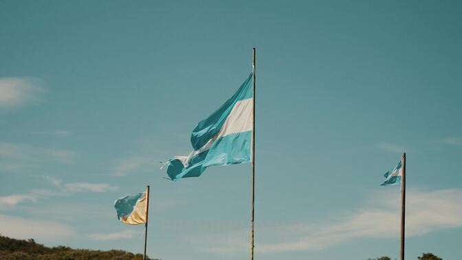 Flags Of Argentina And Tierra Del Fuego Waving With The Wind In Patagonia Slow Motion Stock