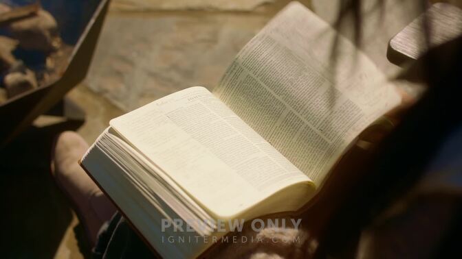 Woman Flipping Through Pages Of Bible On Windy Day In The Woods - Stock ...