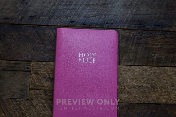 A Bright Pink Bible On A Wooden Table. - Stock Photos | Pearl